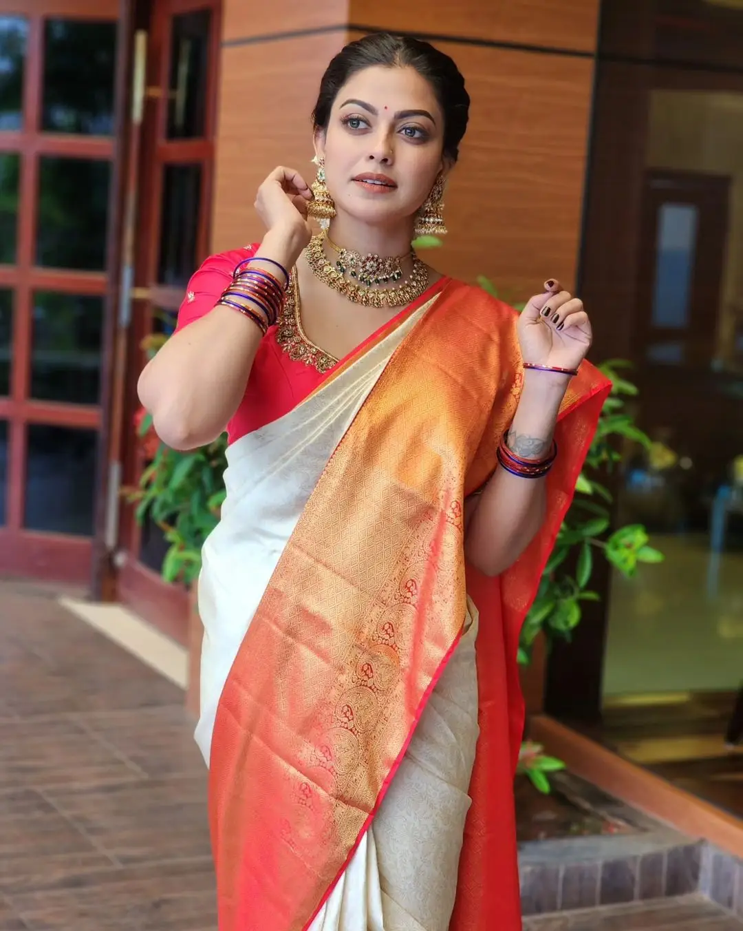 Anusree Nair Wearing Beautiful Earrings Jewellery White Saree Orange Blouse